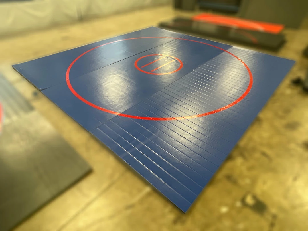 AK Athletic Equipment Wrestling Mats CLEARANCE 14' X 14' X 1 3/8" Roll Up Wrestling Mat - BLUE WITH RED CIRCLES 1 AK Athletic Equipment Wrestling Mats CLEARANCE 14' X 14' X 1 3/8" Roll Up Wrestling Mat - BLUE WITH RED CIRCLES